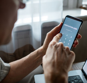Man looking at his phone and getting a verification code