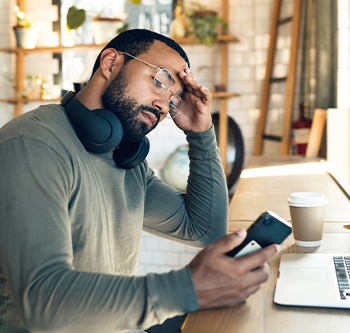 Man looking stressed looking at his phone