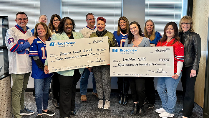 two charities holding up checks