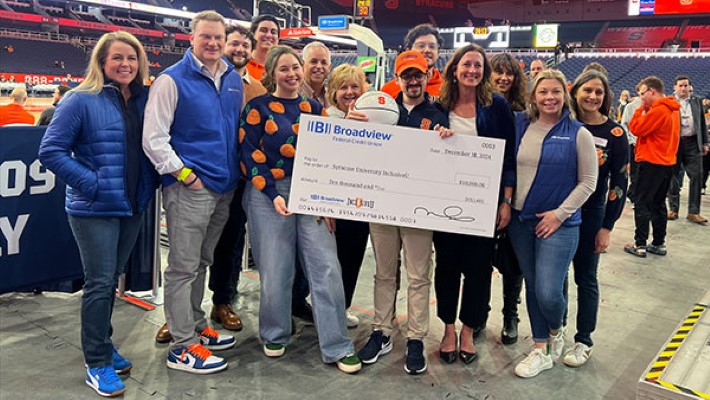 Broadview employees and sponsors holding check