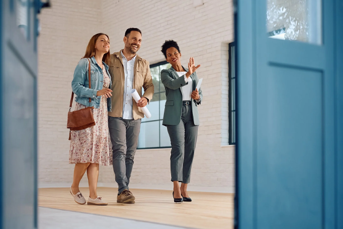 Couple walking through house with realtor