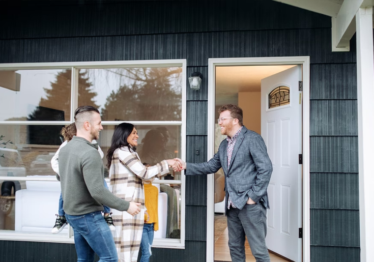 Couple shaking hands with a realtor