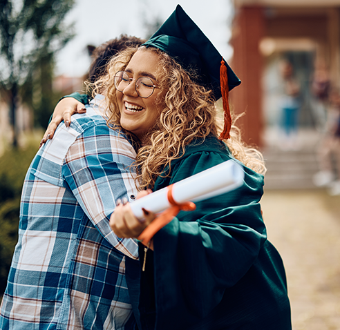 Graduate hugging parent