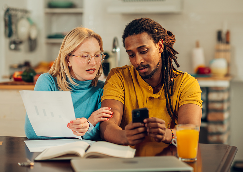 man and woman looking at their budget